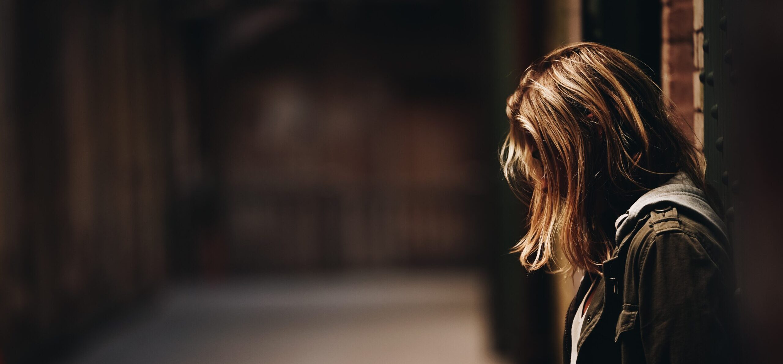 Person standing alone in deep thought